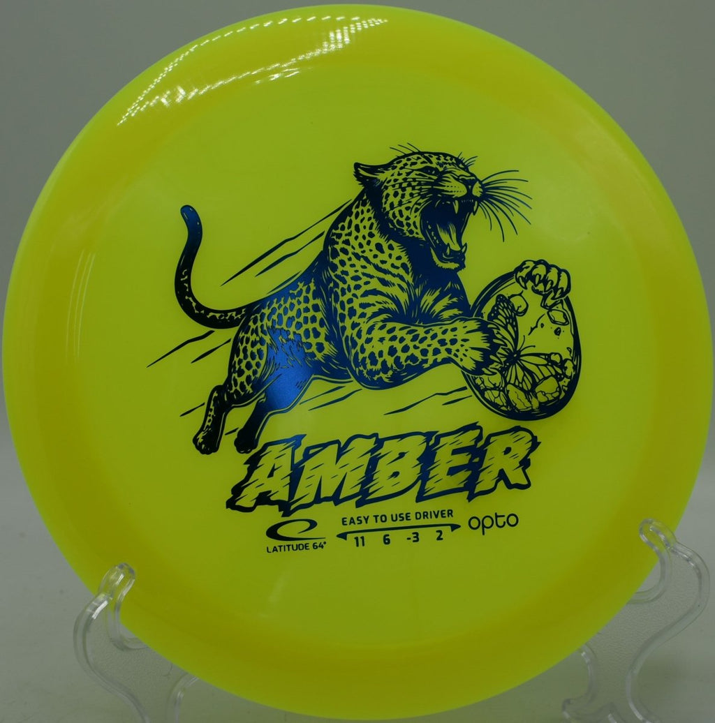 Latitude 64 Opto Amber showcased at Northwood Black Disc Golf Course in Morton, Illinois, engineered for controlled disc golf distance