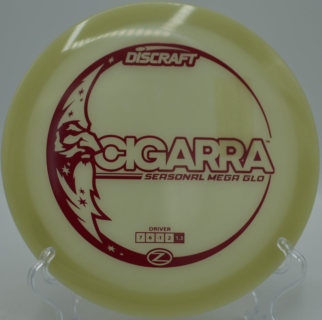 Mega Glow Z Cigarra glowing at rest beside the pole at Winthrop Gold Disc Golf Course in Rock Hill, South Carolina.