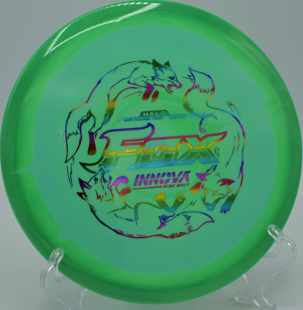 Innova Halo Star Fox held in a fan grip before release at Hornets Nest Disc Golf Course in Charlotte, North Carolina.