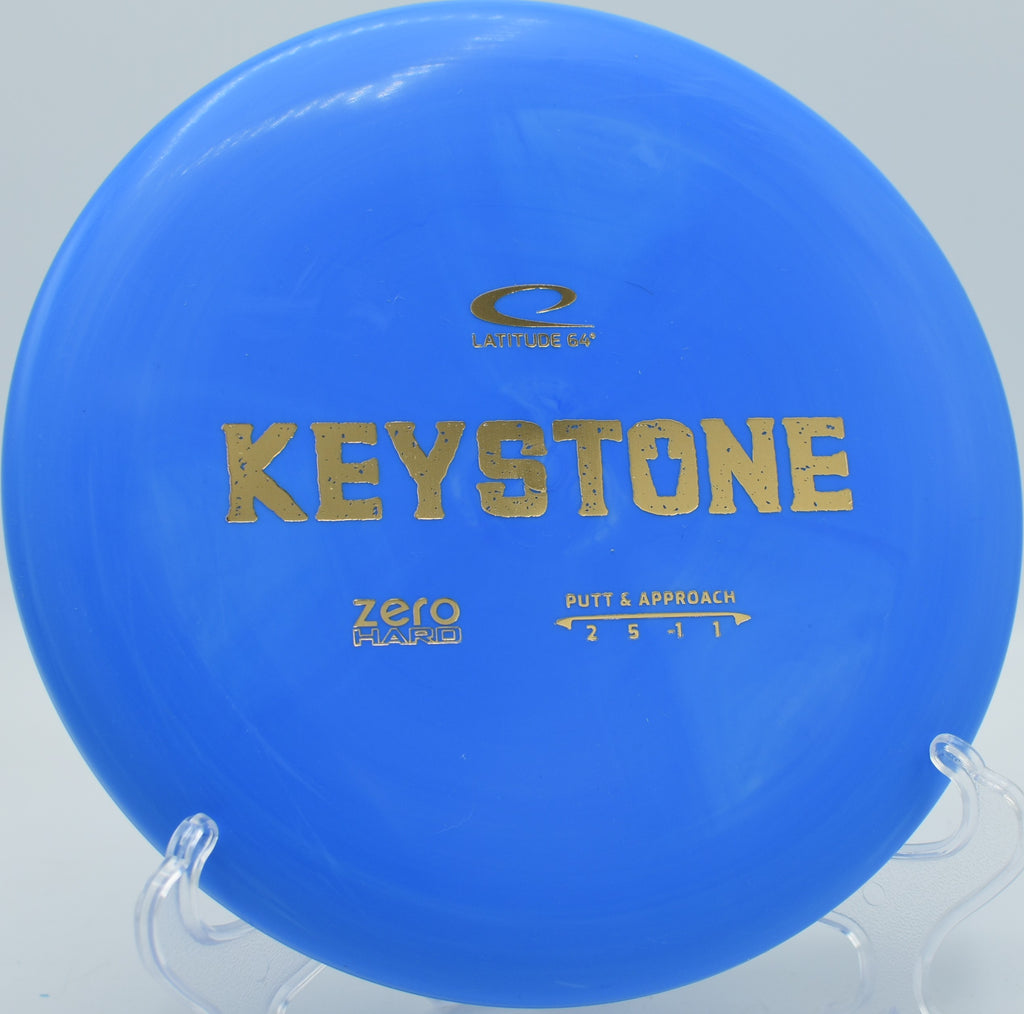 Close-up of a Zero Hard Keystone putter on the tee pad at Water Works Park in Kansas City, Missouri, highlighting its beadless design and durable base plastic.




