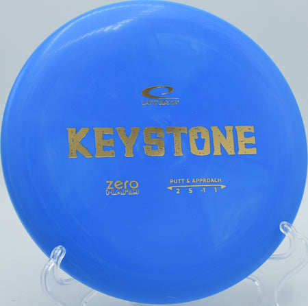 Close-up of a Zero Hard Keystone putter on the tee pad at Water Works Park in Kansas City, Missouri, highlighting its beadless design and durable base plastic.




