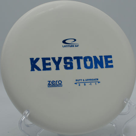 Latitude 64° Zero Medium Keystone resting on trimmed grass at Idlewild Disc Golf Course in Burlington, Kentucky, ideal for straight putts and soft turnovers.

