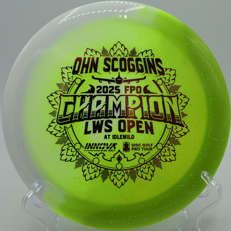 Ohn Scoggins commemorative disc flying through a headwind drive at Harmony Bends Disc Golf Course, Columbia, MO.