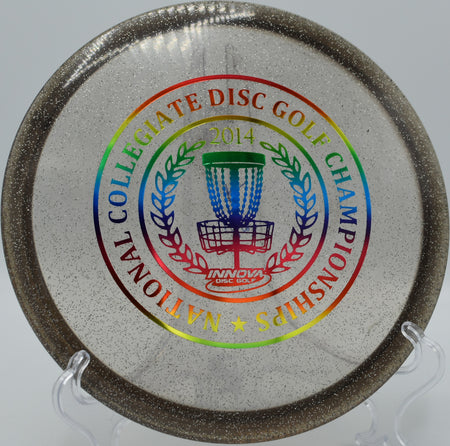 Metal Flake Champion Roc3 resting beside a rocky green at Iron Hill Disc Golf Course in Newark, Delaware, highlighting its overstability and premium grip in challenging terrain.







