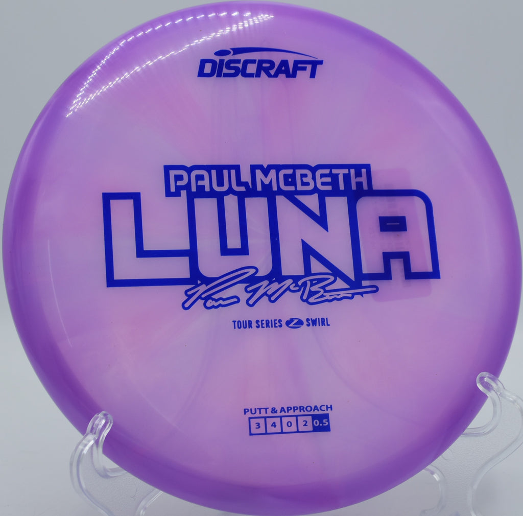 Luna in swirled Z plastic caught mid-approach at Lakewood King County Disc Golf Course in Washington, designed for stable, touch-controlled putts.

