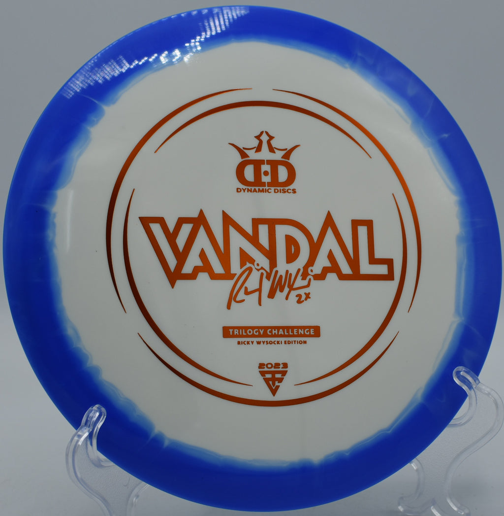 Fuzion-Ice Orbit Vandal Trilogy Challenge 2023 flying down a wooded fairway at Maple Hill Disc Golf Course in Leicester, Massachusetts, with Ricky Wysocki signature stamp and reliable turn.

