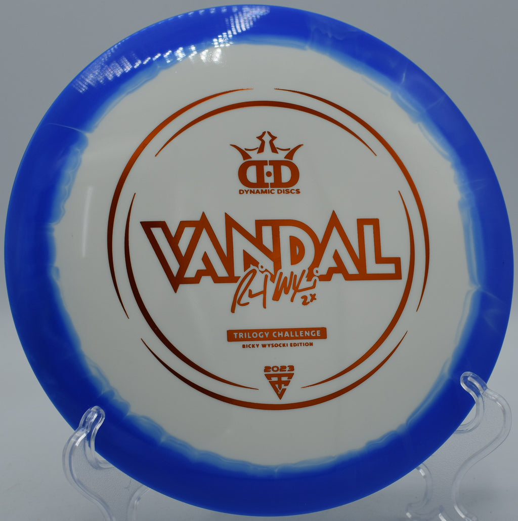 Dynamic Discs Fuzion-Ice Orbit Vandal resting on trimmed grass at Idlewild Disc Golf Course in Burlington, Kentucky, featuring Orbit rim and smooth fairway control.

