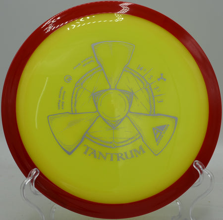 Axiom Neutron Tantrum carving a wide S-curve through an open field at Maple Hill Disc Golf Course.

