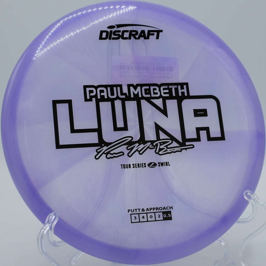 Z Swirl Luna fading cleanly beside a water hazard at Brickyard Disc Golf Course in Menifee, California, ideal for stress-free putts and short-range drives.

