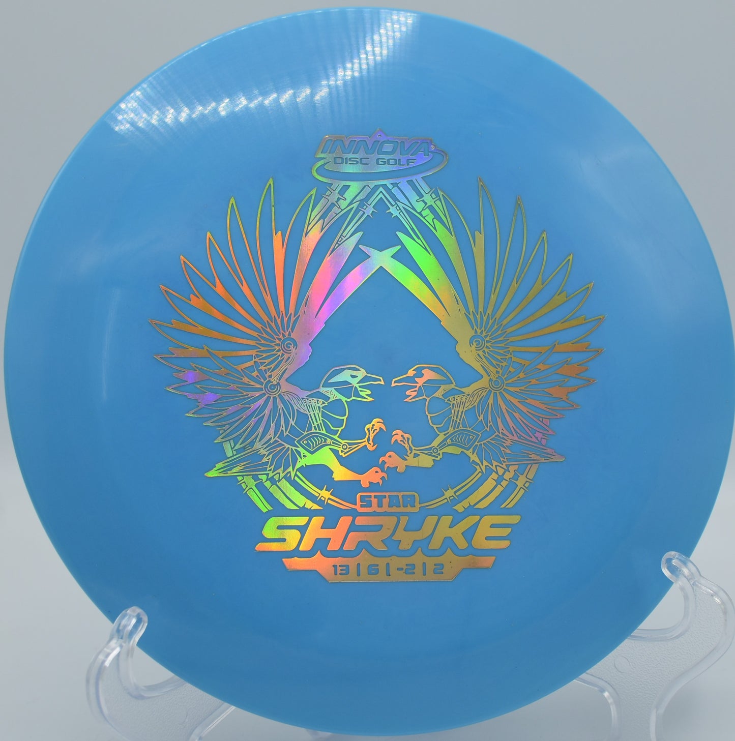 Innova Star Shryke resting on trimmed grass at Eagles Landing DGC in Belton, Missouri, perfect for long turnover shots and booming tailwind drives.