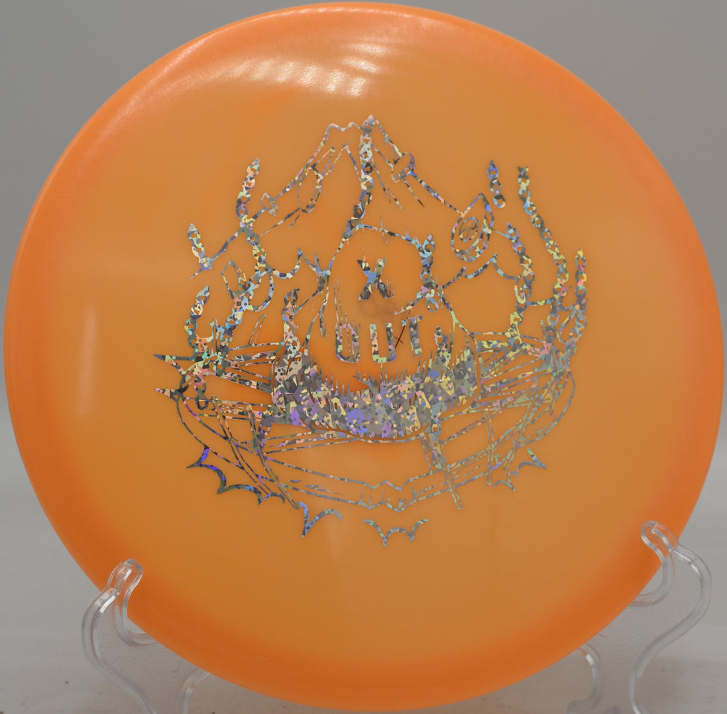 Infinite Discs Anubis shown in-hand before a backhand upshot at SeaTac Disc Golf Course in Washington

