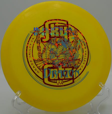 DX Dragon floating near the edge of a water hazard at Lakewood King County Disc Golf Course in Washington, highlighting its lightweight build, high glide, and water-floating plastic ideal for newer players.