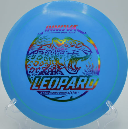 Innova Star Leopard driver resting beside chains after a smooth approach shot at Cedar Hill Park Disc Golf Course in Nashville, Tennessee