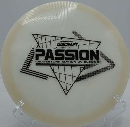 Glowing Discraft UV Z Passion carving technical lines at Harmon Hills Disc Golf Course in Tennessee, perfect for players seeking precision control