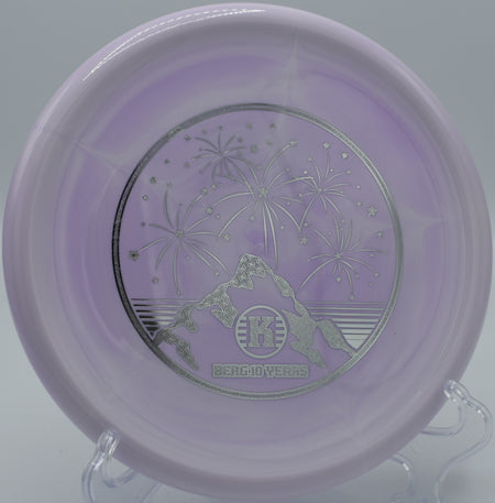 Close-up of a K1 Swirl Berg resting on mossy ground at Milo McIver Disc Golf Course in Estacada, Oregon