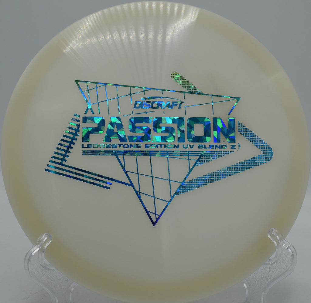 UV-reactive Discraft Passion glowing mid-flight at SeaTac Disc Golf Course in Washington, ideal for shaping lines in tight wooded conditions