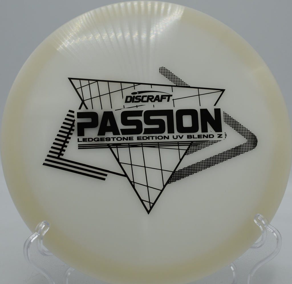 Paige Pierce Signature UV Z Passion disc glowing bright in UV light on hole 8 at The Rez Disc Golf Course in Brandon, Mississippi—tailor-made for wooded gaps