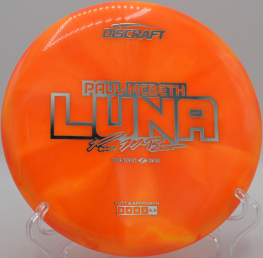 Discraft Luna in Z Swirl plastic parked near a rock wall at Golden Gate Park DGC in San Francisco, California, made for clean spin control.

