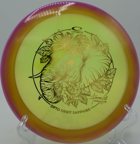 Bright Orbit rim of the Opto Sapphire glowing in the sun at Winthrop Gold Disc Golf Course in Rock Hill, South Carolina.

