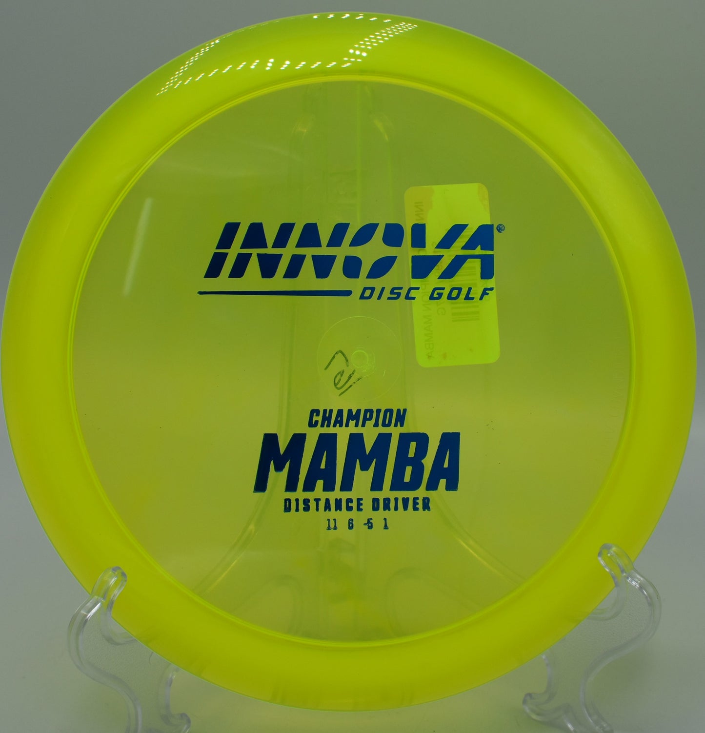 An Innova Champion Mamba landing softly on the green at Maple Hill Disc Golf Course in Leicester, Massachusetts, following a controlled understable drive.