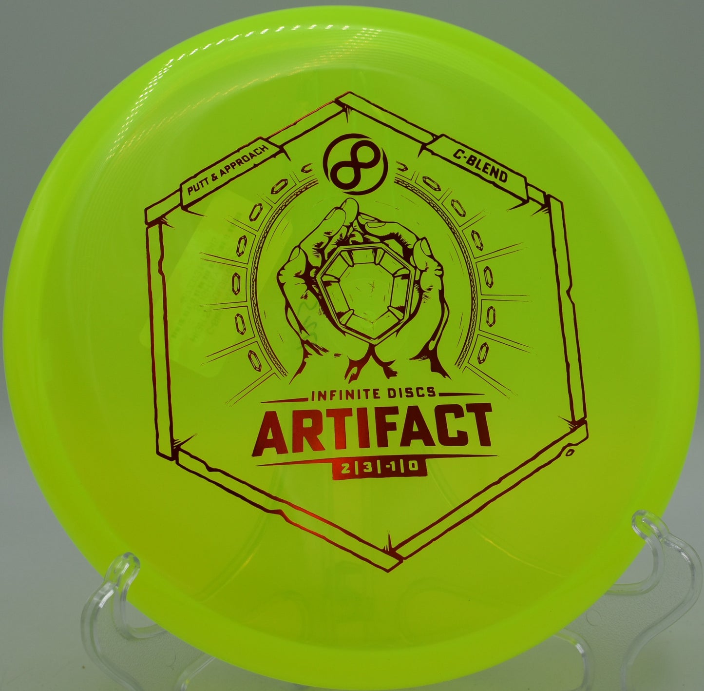 Infinite Discs C-Blend Artifact parked at the base of a hillside pin at DeLaveaga Disc Golf Course in Santa Cruz, California, highlighting its soft finish and neutral flight.

