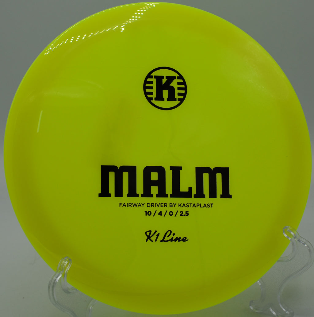 K1 Malm softly landing on the hillside basket area at Branson Trails DGC in Branson, Missouri, glowing in early morning light.

