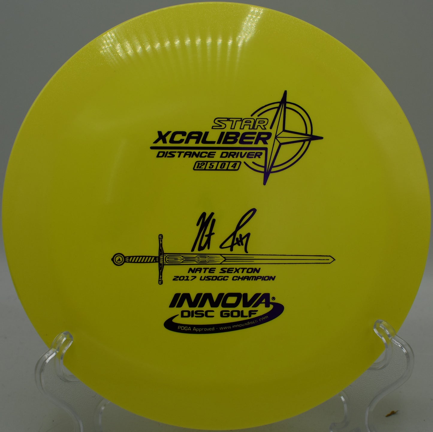 Innova XCaliber landing hard on edge near a wooded pin at Northwood Black in Morton, Illinois

