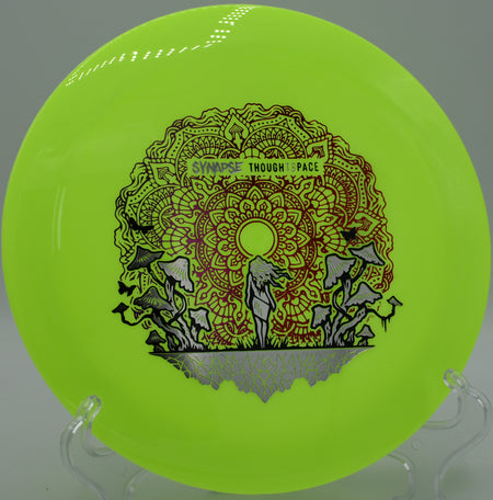 Thought Space Athletics Aura Coalesce resting on trimmed grass at Idlewild Disc Golf Course in Burlington, Kentucky, ideal for shaping stable lines with forehand or backhand.

