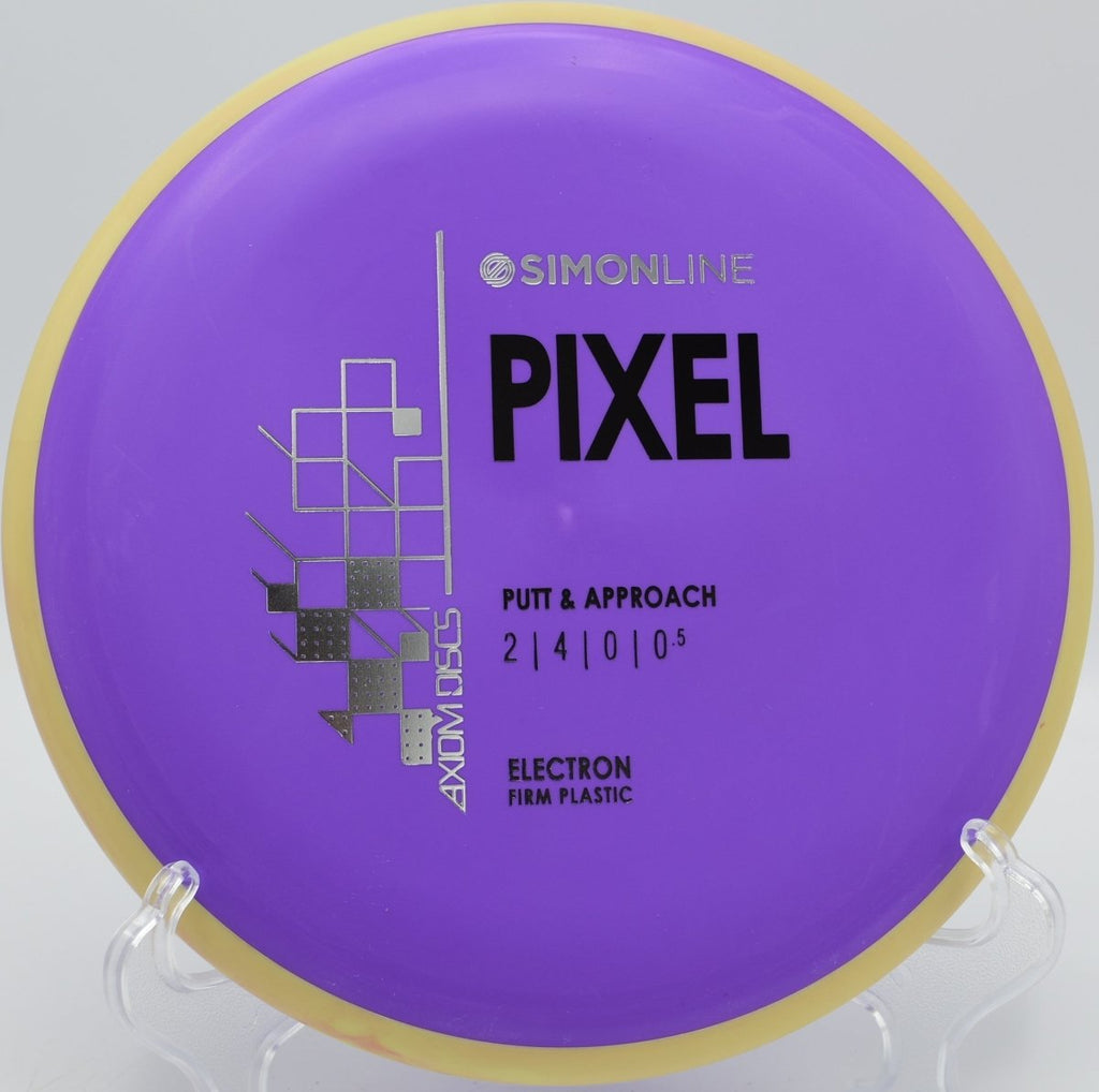 Electron Firm Pixel disc golf putter lying on the putting surface after a soft landing approach at Glen Helen Regional Park Disc Golf Course in San Bernardino, California