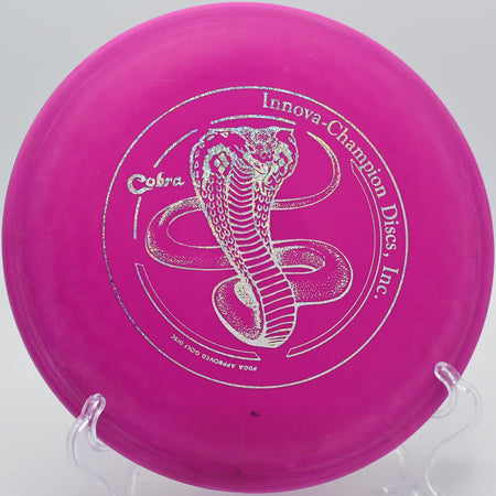 Innova DX Cobra turning over slightly on Hole 12 at Rock Ridge Disc Golf Course, Pittsboro, North Carolina.