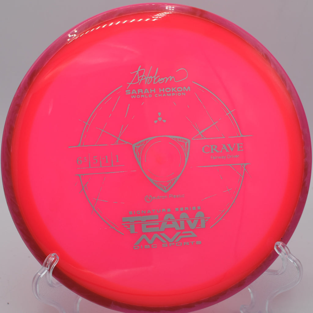Neutron Crave fairway driver displayed on a grassy disc golf course at Golden Gate Park in San Francisco, California, showcasing its sleek design and high-quality Neutron plastic.