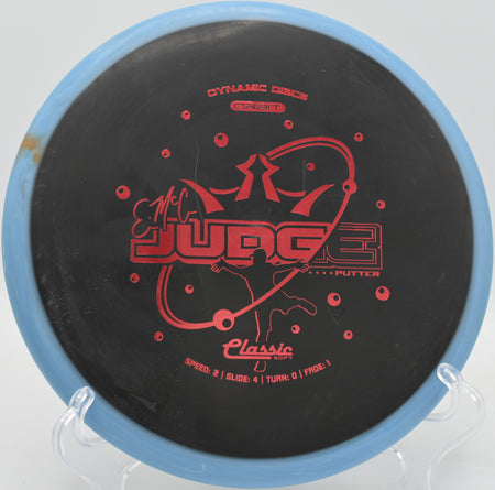 Dynamic Discs Classic Soft Orbit EMAC Judge resting against the chains at Shoaff Park in Fort Wayne, Indiana


