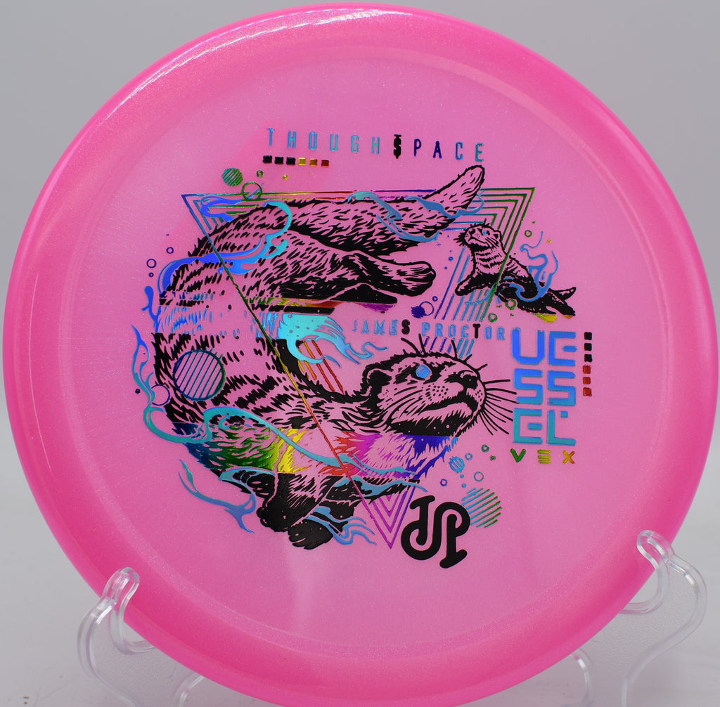 Vex Vessel hugging a tight hyzer line with late fade toward a pin tucked behind trees at Idlewild DGC.

