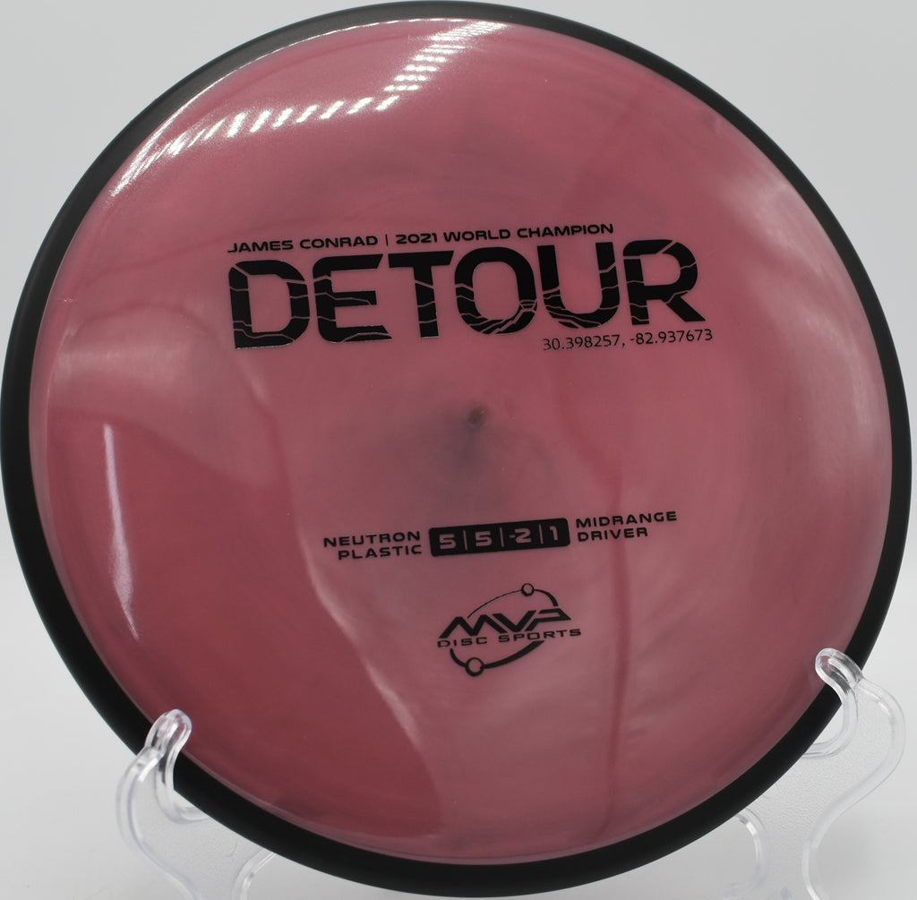 MVP Neutron Detour gliding through a wooded tunnel at Idlewild Disc Golf Course in Burlington, Kentucky, offering controlled understability and smooth finish.

