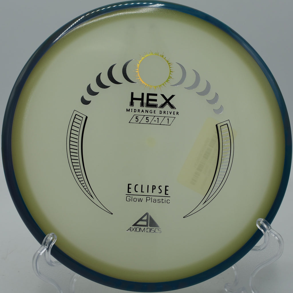 Bright glow Eclipse Hex floating through tight trees at Trophy Club Disc Golf Course in Trophy Club, Texas.


