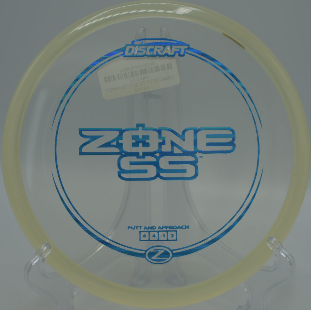 Z Zone SS resting softly beside the cage after a clean release at Blue Ribbon Pines Disc Golf Course in East Bethel, Minnesota.