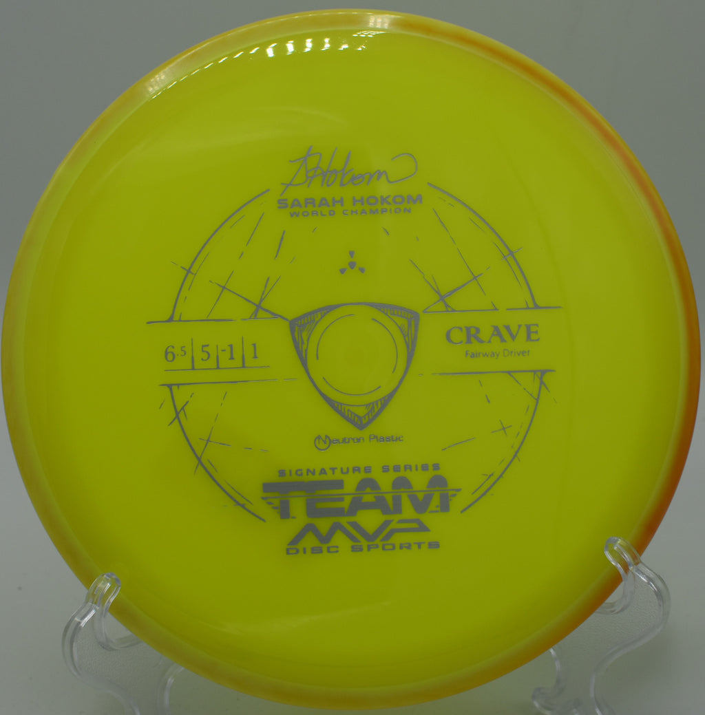 A player holding the Neutron Crave disc before a throw on a wooded fairway at Winthrop University Disc Golf Course in Rock Hill, South Carolina, showcasing its stability and glide for accuracy.

