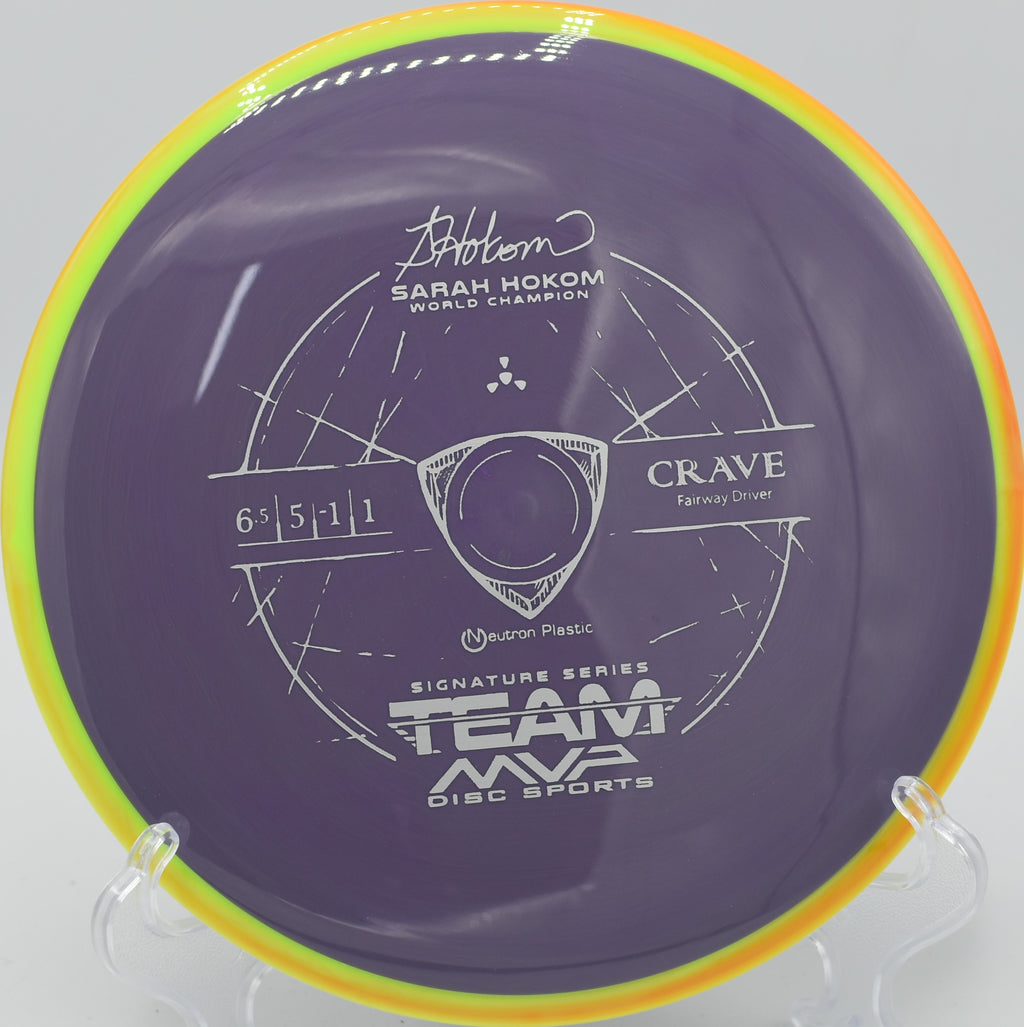 The Neutron Crave resting on a tee pad at Highbridge Hills Disc Golf Course in Highbridge, Wisconsin, with a scenic background showing its versatile use for precision drives.

