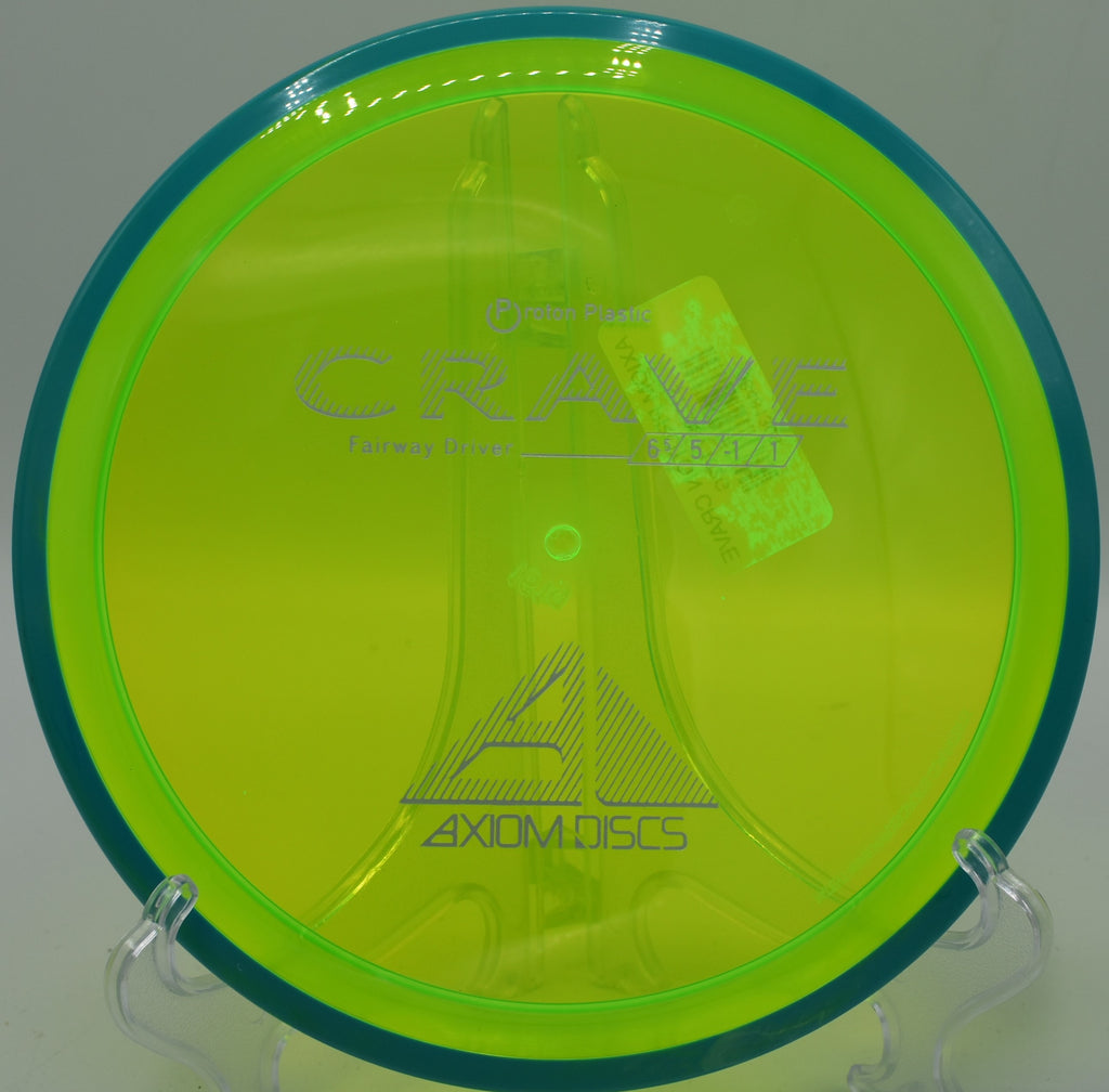 Player gripping a transparent Proton Crave on the tee pad at Red Mountain Disc Golf Course in Mesa, Arizona