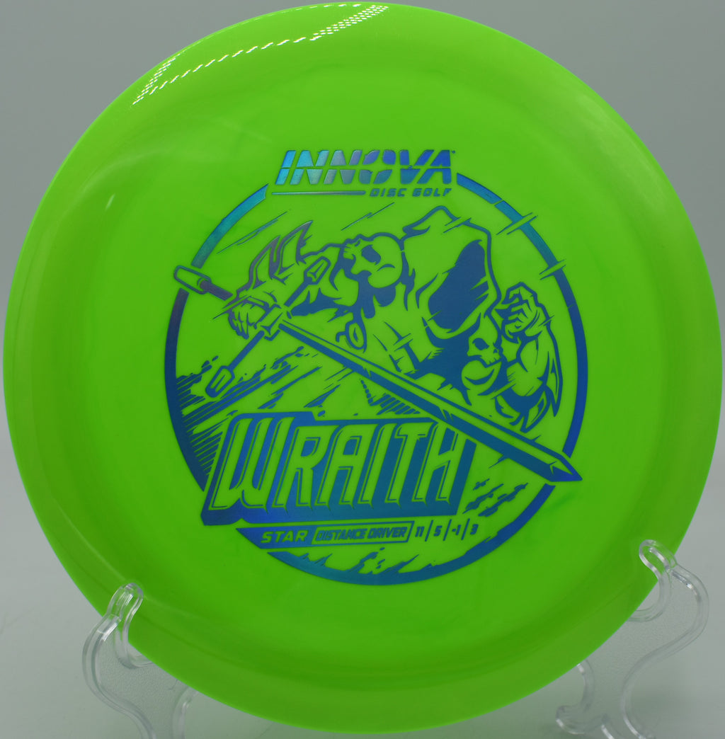 Bright-colored Star Wraith driver resting near the circle at Maple Hill Disc Golf Course in Leicester, Massachusetts, known for its consistent flight and distance potential.


