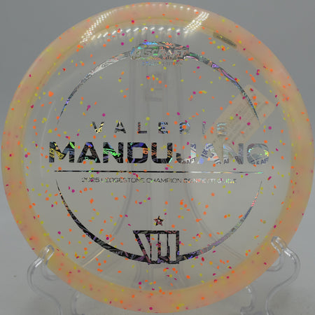 Z Confetti Glide floating down a wooded fairway at Idlewild Disc Golf Course in Burlington, Kentucky