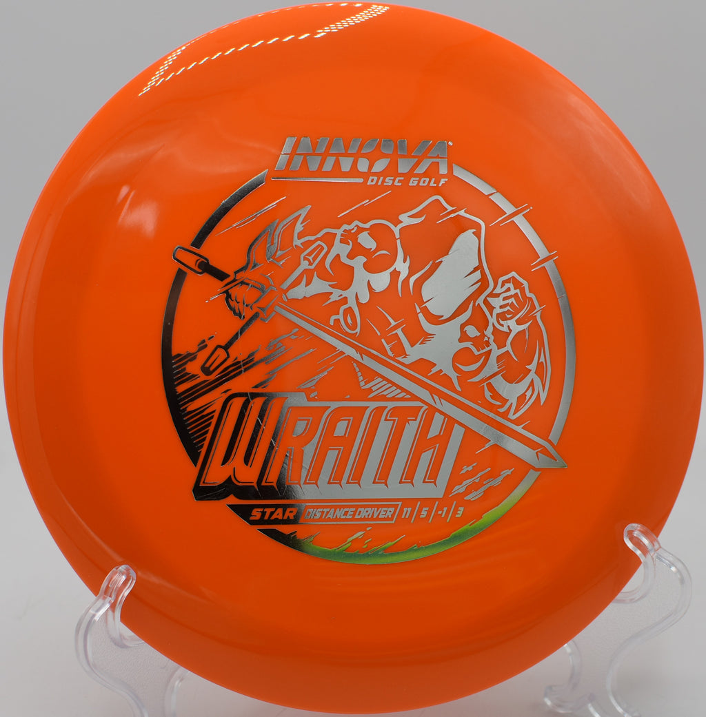 Star Wraith disc sitting on wet grass at Northwood Black in Morton, Illinois, after carving through a technical wooded fairway with high glide and low turn.

