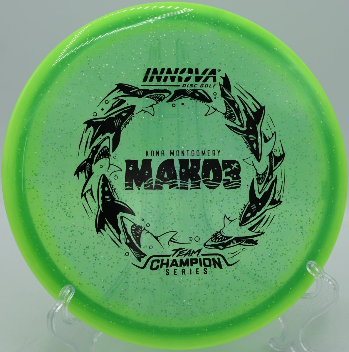 Kona Montgomery Mako3 Tour Series midrange driver photographed at Blue Ribbon Pines Disc Golf Course in East Bethel, Minnesota, perfect for wooded fairway navigation and accurate approach shots