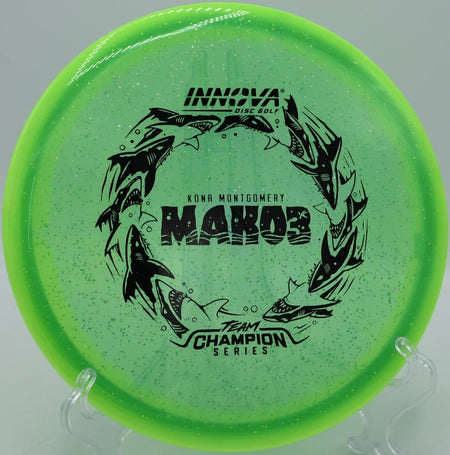 Kona Montgomery Mako3 Tour Series midrange driver photographed at Blue Ribbon Pines Disc Golf Course in East Bethel, Minnesota, perfect for wooded fairway navigation and accurate approach shots