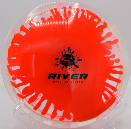 Latitude 64 River resting beside the pin after a long glide at SeaTac Disc Golf Course in Washington

