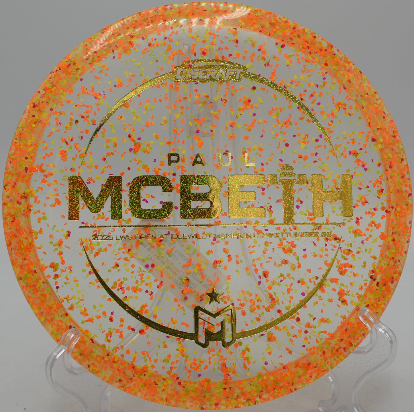 Discraft Buzzz SS Confetti edition gliding through a wooded tunnel at Northwood Black in Morton, Illinois