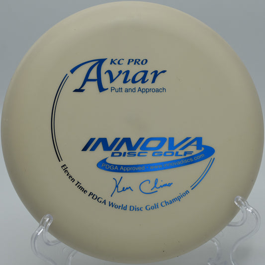 Innova 9x KC Pro Aviar spinning cleanly through a wooded gap on Hole 14 at North Boundary Disc Golf Course, Cranberry Township, Pennsylvania.