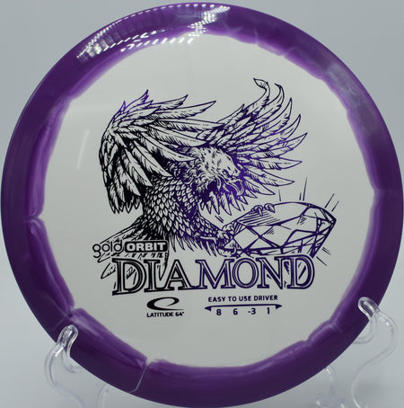 Gold Orbit Diamond floating straight before a soft finish at SeaTac Disc Golf Course in Washington.

