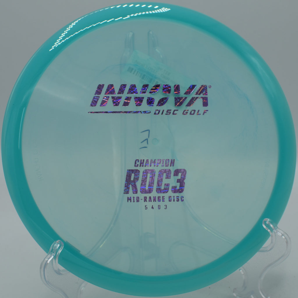 A Champion Roc3 resting near the pin on hole 16 at Water Works Park Disc Golf Course in Kansas City, Missouri, after a smooth downhill shot.