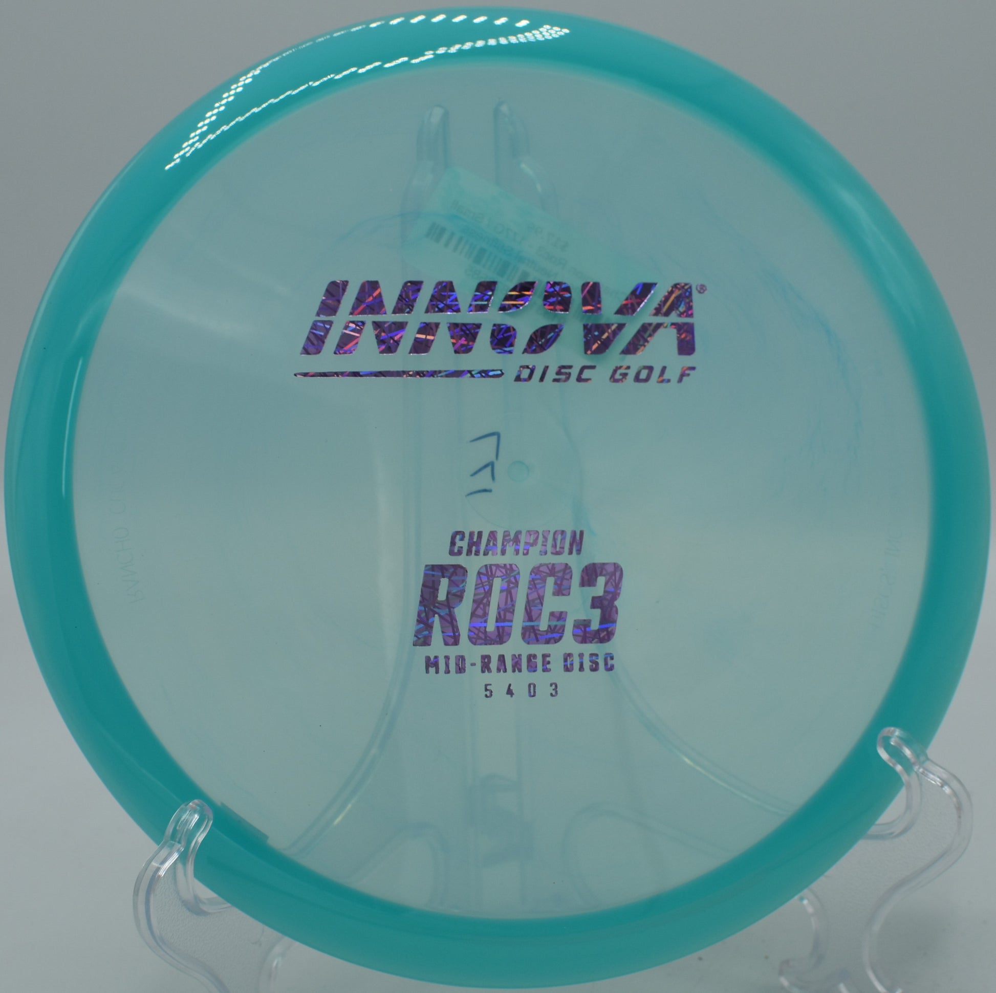 A Champion Roc3 resting near the pin on hole 16 at Water Works Park Disc Golf Course in Kansas City, Missouri, after a smooth downhill shot.